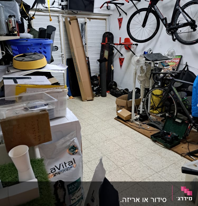 חדר עם אופניים תלויים, קופסאות וכלי עבודה